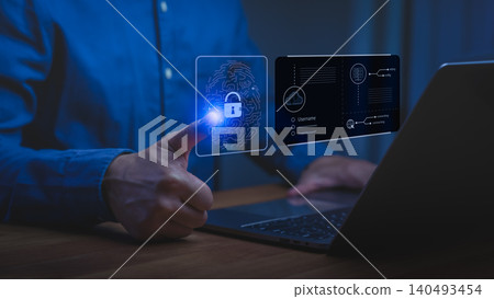 Man using laptop with virtual fingerprint scanner for cybersecurity. Biometric login technology protects digital privacy and data. Man using laptop with virtual fingerprint scanner for cybersecurity. Biometric login technology protects digital privacy and data. 140493454