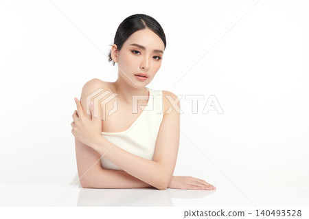 A beautiful young Asian woman with clean, fresh skin against a white background. Skincare, facial treatment, cosmetology, beauty, and spa. An elegant portrait of an Asian woman. A beautiful young Asian woman with clean, fresh skin against a white background. Skincare, facial treatment, cosmetology, beauty, and spa. An elegant portrait of an Asian woman. 140493528