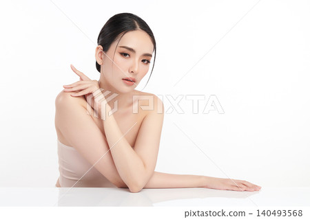 A beautiful young Asian woman with clean, fresh skin against a white background. Skincare, facial treatment, cosmetology, beauty, and spa. An elegant portrait of an Asian woman. 140493568