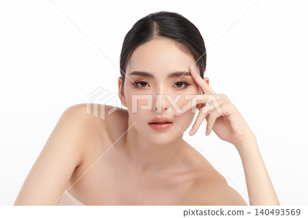 A beautiful young Asian woman with clean, fresh skin against a white background. Skincare, facial treatment, cosmetology, beauty, and spa. An elegant portrait of an Asian woman. 140493569