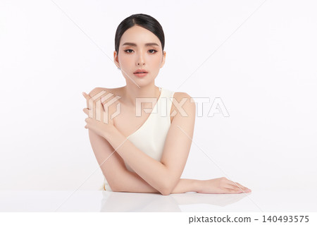 A beautiful young Asian woman with clean, fresh skin against a white background. Skincare, facial treatment, cosmetology, beauty, and spa. An elegant portrait of an Asian woman. A beautiful young Asian woman with clean, fresh skin against a white background. Skincare, facial treatment, cosmetology, beauty, and spa. An elegant portrait of an Asian woman. 140493575