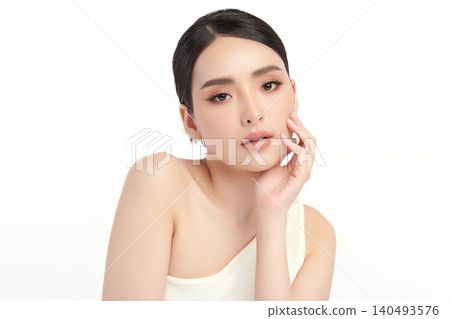 A beautiful young Asian woman with clean, fresh skin against a white background. Skincare, facial treatment, cosmetology, beauty, and spa. An elegant portrait of an Asian woman. A beautiful young Asian woman with clean, fresh skin against a white background. Skincare, facial treatment, cosmetology, beauty, and spa. An elegant portrait of an Asian woman. 140493576