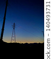 The landscape of transmission towers emerging in the pre-dawn hours 140493731