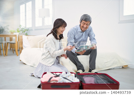 A smiling senior couple preparing for a trip. A smiling senior couple preparing for a trip. 140493739