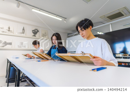 Students drawing side-by-side at an art preparatory school. Students drawing side-by-side at an art preparatory school. 140494214