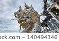 Ornate Naga Serpent Sculpture at Thai Temple with Silver Mosaic 140494346