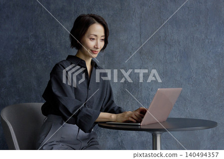Businesswoman using a computer black background Businesswoman using a computer black background 140494357