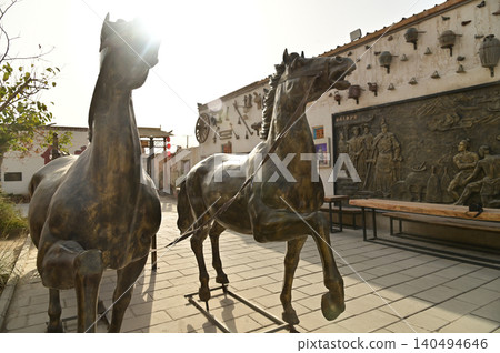 The ancient metal horses and carriage statues in the ancient city of Kuche on the Silk Road and the enchanting city of Aksu. Kuche, a colorful ancient kingdom. The ancient metal horses and carriage statues in the ancient city of Kuche on the Silk Road and the enchanting city of Aksu. Kuche, a colorful ancient kingdom. 140494646