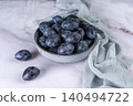 Fresh plums in a clay bowl. 140494722