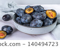 Fresh plums in a clay bowl. 140494723