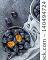 Fresh plums in a clay bowl. 140494724