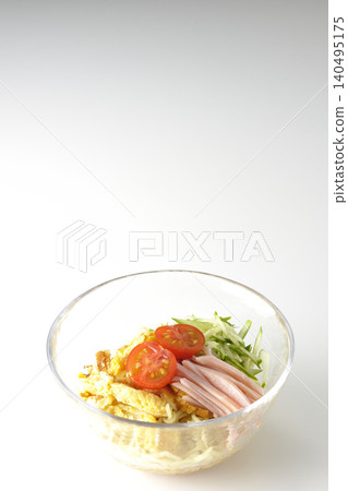 A single photograph of chilled ramen served in a clear glass bowl against a white background. 140495175