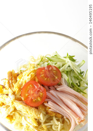 A single photograph of chilled ramen served in a clear glass bowl against a white background. A single photograph of chilled ramen served in a clear glass bowl against a white background. 140495195