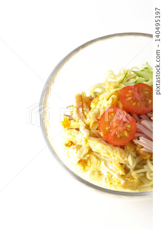 A single photograph of chilled ramen served in a clear glass bowl against a white background. A single photograph of chilled ramen served in a clear glass bowl against a white background. 140495197