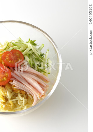 A single photograph of chilled ramen served in a clear glass bowl against a white background. A single photograph of chilled ramen served in a clear glass bowl against a white background. 140495198