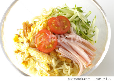 A single photograph of chilled ramen served in a clear glass bowl against a white background. A single photograph of chilled ramen served in a clear glass bowl against a white background. 140495199