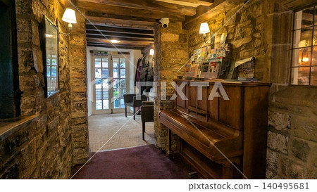 Stone interior of a British hotel and piano 140495681