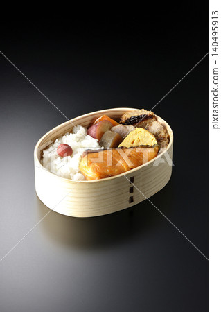 Grilled fish bento photographed against a black background Grilled fish bento photographed against a black background 140495913