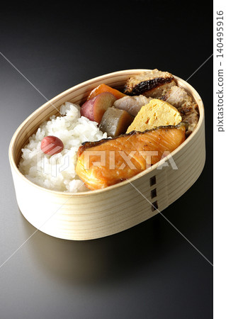 Grilled fish bento photographed against a black background Grilled fish bento photographed against a black background 140495916