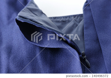 Unzipping a garment Unzipping a garment 140496372