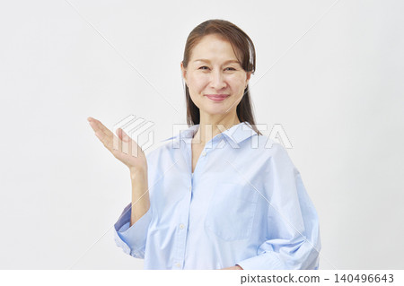 A woman pointing to the left with her palm on a white background A woman pointing to the left with her palm on a white background 140496643