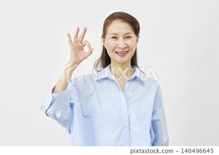 A woman making an OK sign on a white background A woman making an OK sign on a white background 140496645