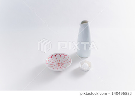 An image of a Shinto ritual or purification using a sake bottle and salt dish. 140496883