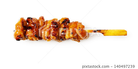 A single skewer of grilled chicken skin with sauce, isolated against a white background, with a shadow, horizontal orientation, cutout material. A single skewer of grilled chicken skin with sauce, isolated against a white background, with a shadow, horizontal orientation, cutout material. 140497239
