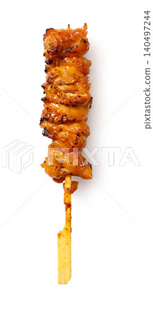 A single skewer of grilled chicken skin with sauce, isolated against a white background, with a shadow, vertical orientation, cutout image. A single skewer of grilled chicken skin with sauce, isolated against a white background, with a shadow, vertical orientation, cutout image. 140497244