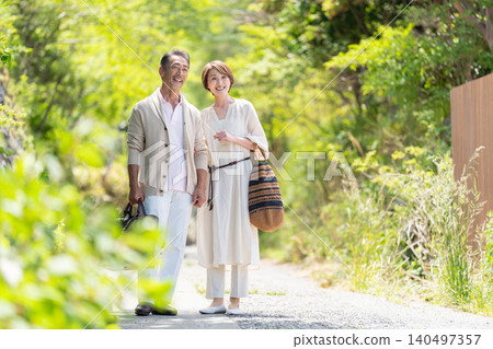 A smiling senior couple enjoying a domestic trip in early summer. A smiling senior couple enjoying a domestic trip in early summer. 140497357