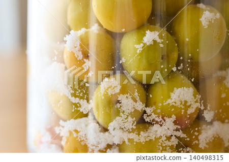 Pickle the plums in a storage container. Pickle the plums in a storage container. 140498315