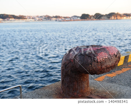 Mooring posts standing on the quay; seascape; copy space; background; wabi-sabi; art of rust. Mooring posts standing on the quay; seascape; copy space; background; wabi-sabi; art of rust. 140498341