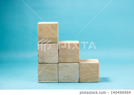 Six blank wooden blocks arranged in a staircase structure to represent growth, decline, or a developmental path. High Quality Photo 140498484