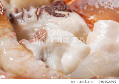 A platter of fresh seafood, featuring close-ups of octopus and shrimp sashimi. A platter of fresh seafood, featuring close-ups of octopus and shrimp sashimi. 140498895