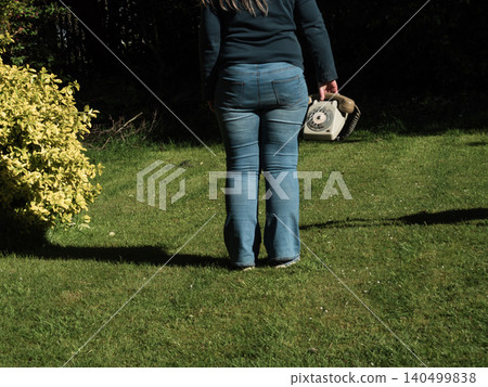 Woman holding vintage phone outside  140499838