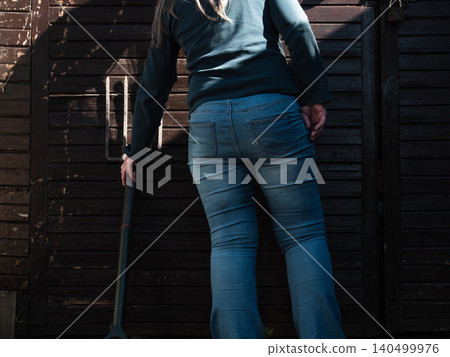 Woman opens gets gardening fork Woman opens gets gardening fork 140499976