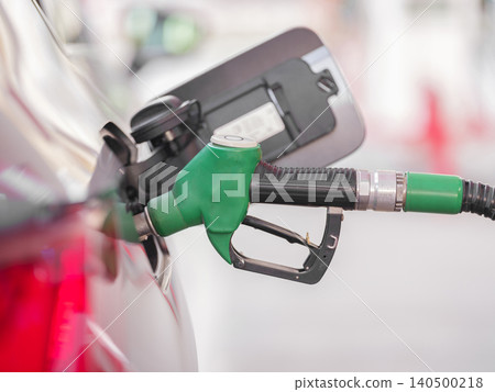 Pumping gas at gas pump Pumping gas at gas pump 140500218