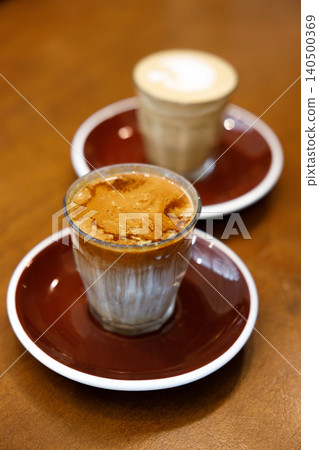 Glass of milk latte coffee on a wooden table. 140500369