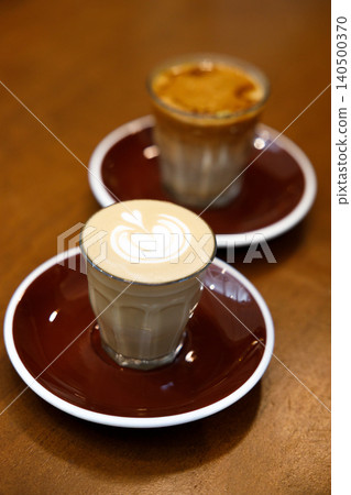 Glass of milk latte coffee on a wooden table. 140500370