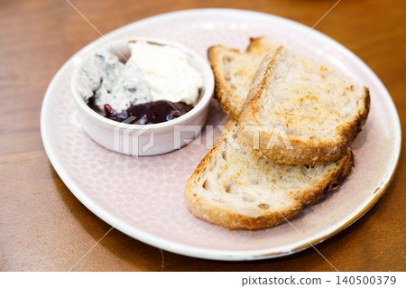 Toast sourdough bread with butter spread on a wooden table. Toast sourdough bread with butter spread on a wooden table. 140500379