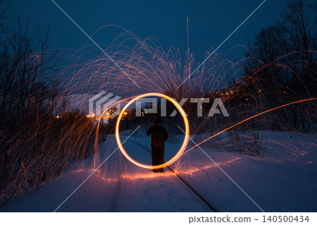 Fire painting at winter at night in abandoned place Fire painting at winter at night in abandoned place 140500434