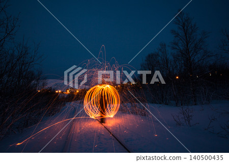 Fire painting at winter at night in abandoned place 140500435
