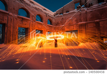 Fire painting at winter at night in abandoned place Fire painting at winter at night in abandoned place 140500438