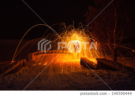 Fire painting at winter at night in abandoned place 140500444