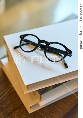 A book and glasses on the desk A book and glasses on the desk 140500647