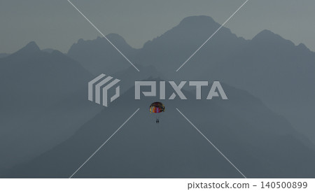 Tourists soaring high above the sea while parasailing 140500899