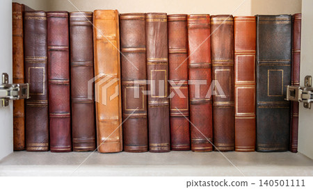Antique leather bound books collection in cabinet. Set of ancient law book on bookshelf in library 140501111