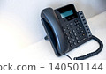 IP phone on the table in hotel room. Black landline telephone for communication support 140501144