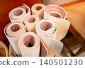 Group of rolled yoga mats in fitness gym 140501230