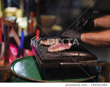 fresh beef steaks cooking on the grill 140501460